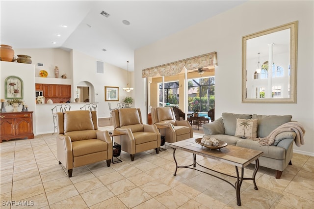 living room featuring ceiling fan and vaulted ceiling