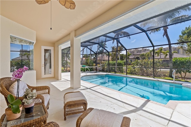 view of pool featuring glass enclosure and a patio