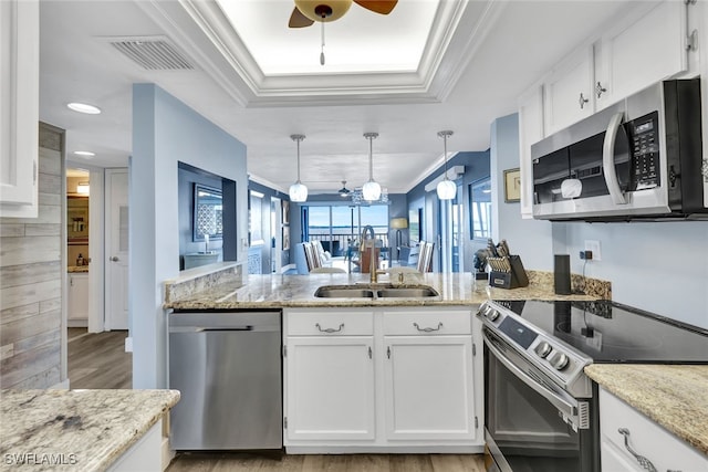 kitchen featuring white cabinetry, appliances with stainless steel finishes, sink, and crown molding