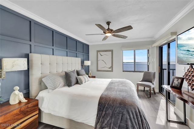 bedroom with crown molding, wood-type flooring, and ceiling fan