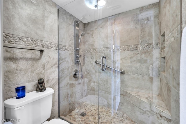 bathroom with walk in shower and toilet