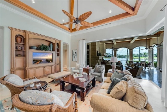 living room with ceiling fan, crown molding, and a high ceiling