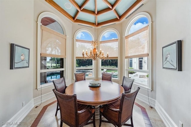 tiled dining room featuring coffered ceiling and a chandelier