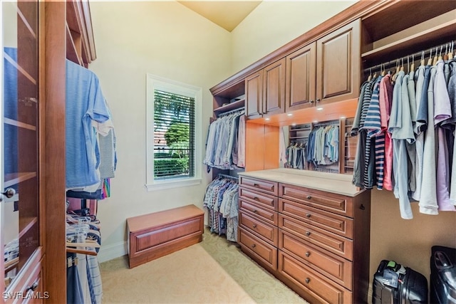 walk in closet featuring light carpet