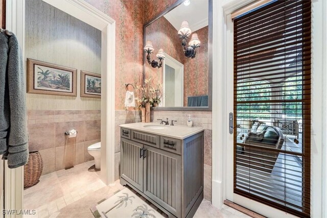 bathroom with tile patterned flooring, vanity, and toilet