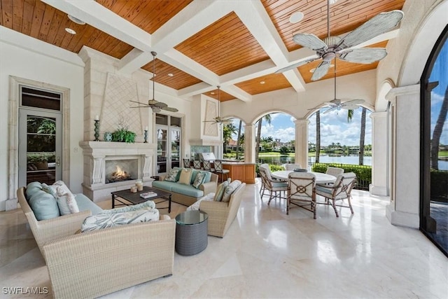 interior space featuring beam ceiling, a fireplace, wood ceiling, and coffered ceiling