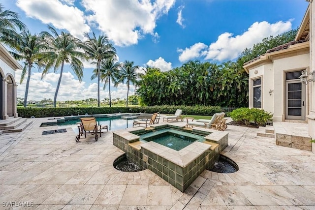 view of swimming pool with an in ground hot tub and a patio