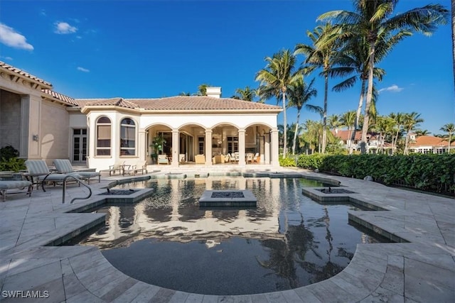 view of pool with a patio area and a jacuzzi