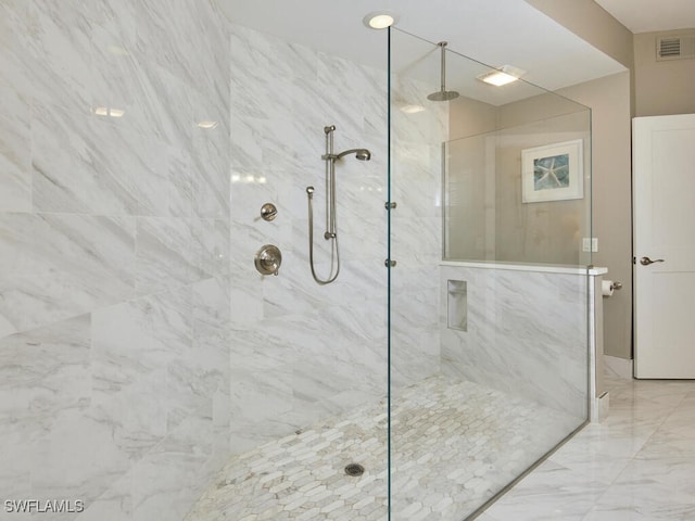 bathroom with a tile shower