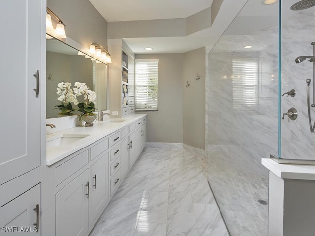 bathroom featuring a tile shower and vanity