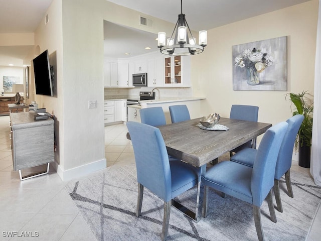 dining space featuring a chandelier and light tile patterned floors