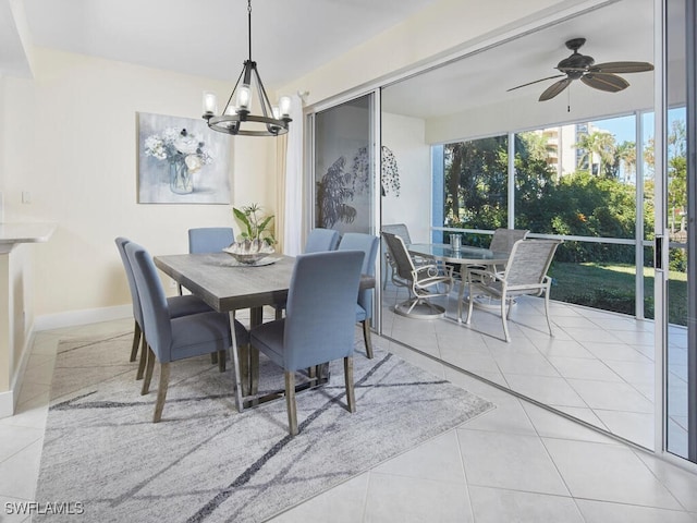 tiled dining area with ceiling fan with notable chandelier