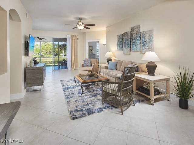 tiled living room with ceiling fan