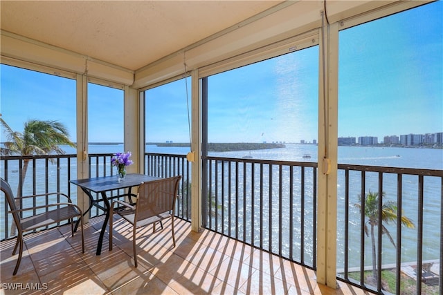 sunroom / solarium with a water view