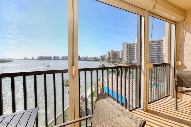 sunroom / solarium featuring a water view