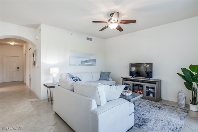 living room with ceiling fan and light tile patterned flooring