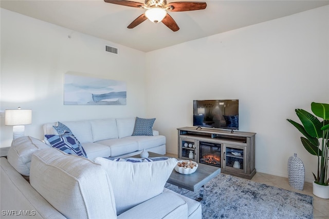 living room featuring ceiling fan and light tile patterned flooring