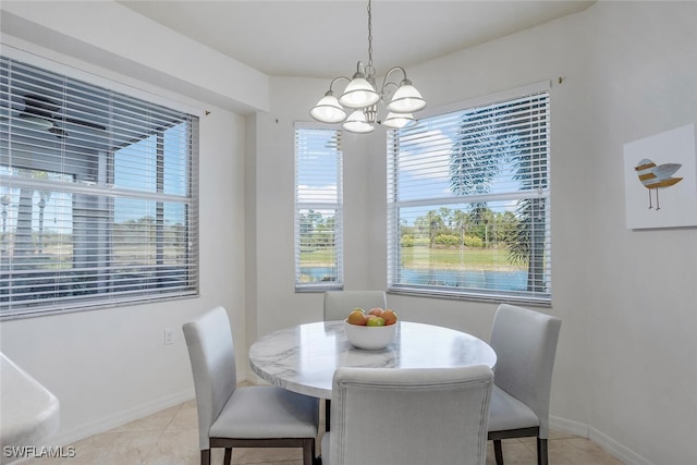 dining area featuring a notable chandelier and light tile patterned flooring