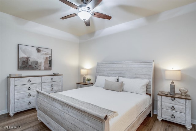 bedroom featuring ceiling fan and dark hardwood / wood-style floors