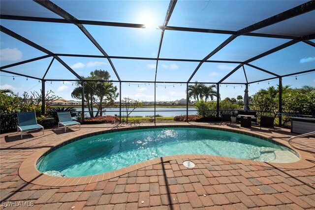 view of swimming pool featuring a water view, glass enclosure, and a patio area