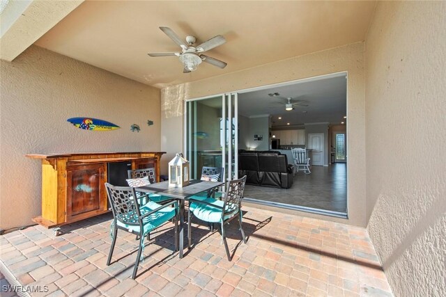 view of patio featuring ceiling fan