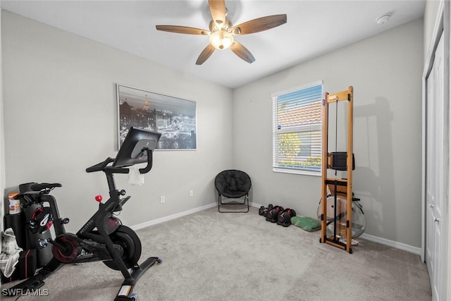 workout area featuring light carpet and ceiling fan