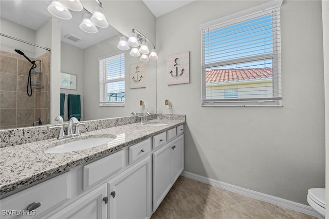 bathroom with tile patterned flooring, vanity, and toilet