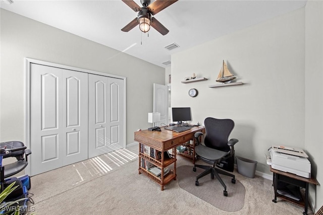 carpeted office space with ceiling fan