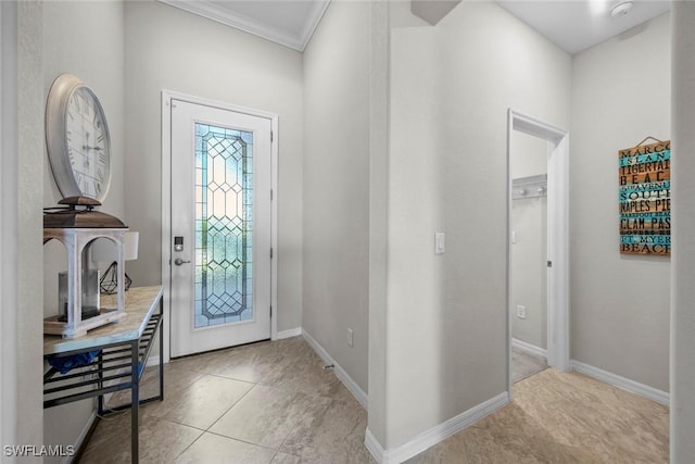 tiled foyer with ornamental molding