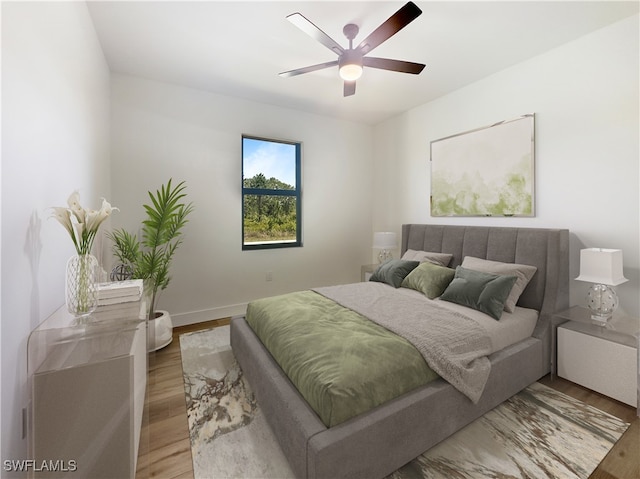 bedroom with hardwood / wood-style flooring and ceiling fan