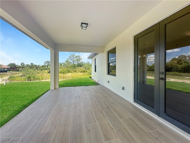 deck with a lawn and french doors