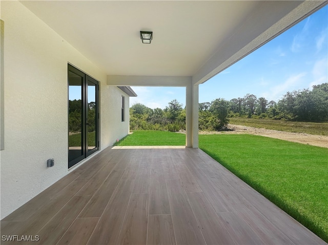 wooden terrace with a yard