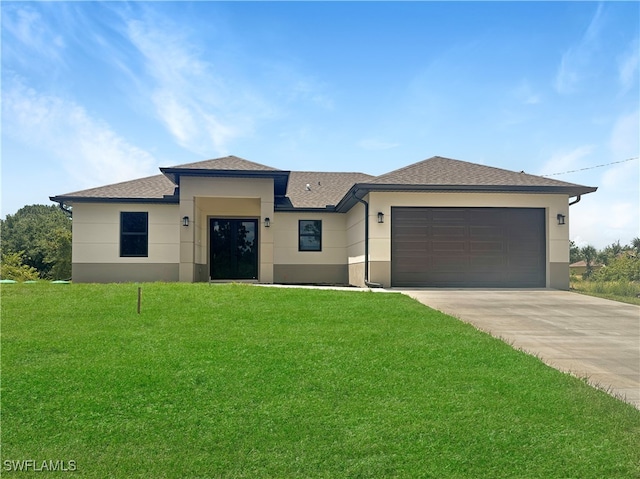 view of front of property with a front yard and a garage