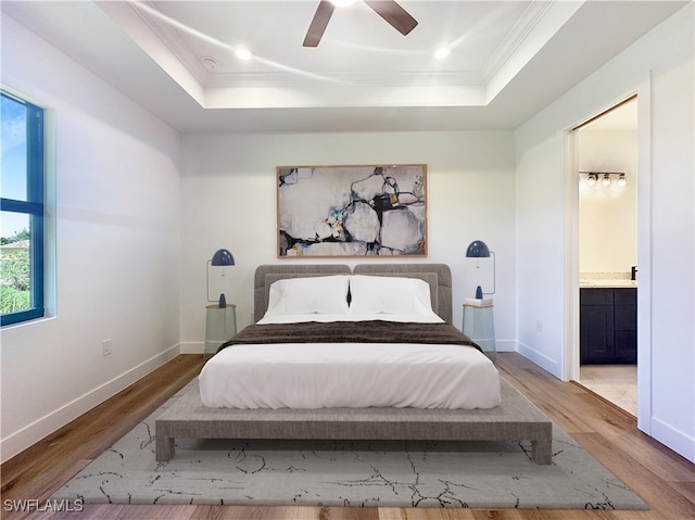 bedroom featuring ensuite bath, ceiling fan, hardwood / wood-style floors, and crown molding