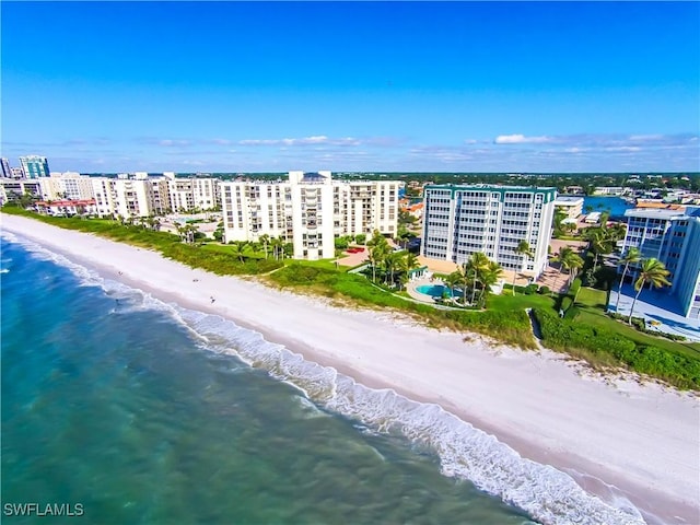 birds eye view of property featuring a beach view and a water view