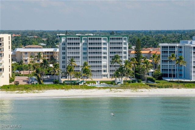 exterior space featuring a water view and a view of the beach