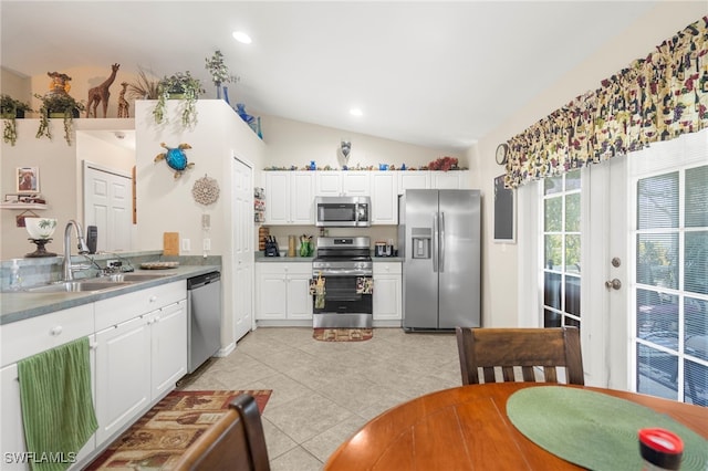 1744 SW 15th St, Cape Coral, FL 33991 - kitchen with appliances with stainless steel finishes, lofted ceiling, light tile patterned floors, white cabinets, and recessed lighting