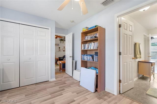 bedroom with ceiling fan, a closet, and light wood-type flooring