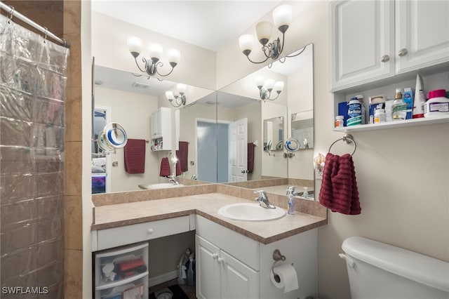 bathroom featuring a shower with shower curtain, vanity, an inviting chandelier, and toilet