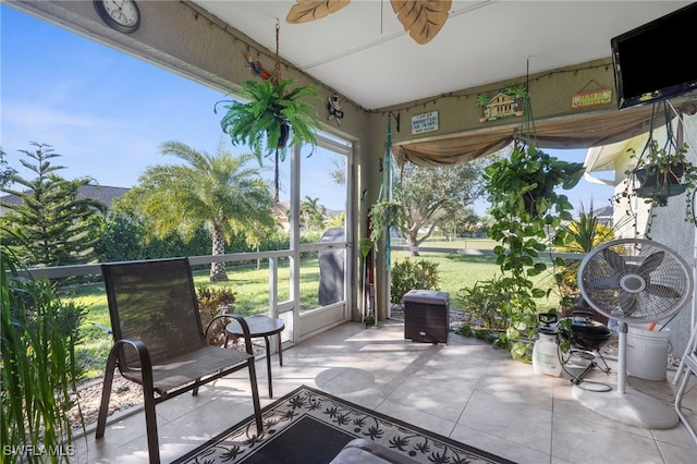 unfurnished sunroom featuring plenty of natural light and ceiling fan