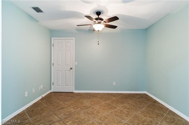 tiled empty room with ceiling fan