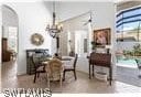 dining room with ceiling fan with notable chandelier