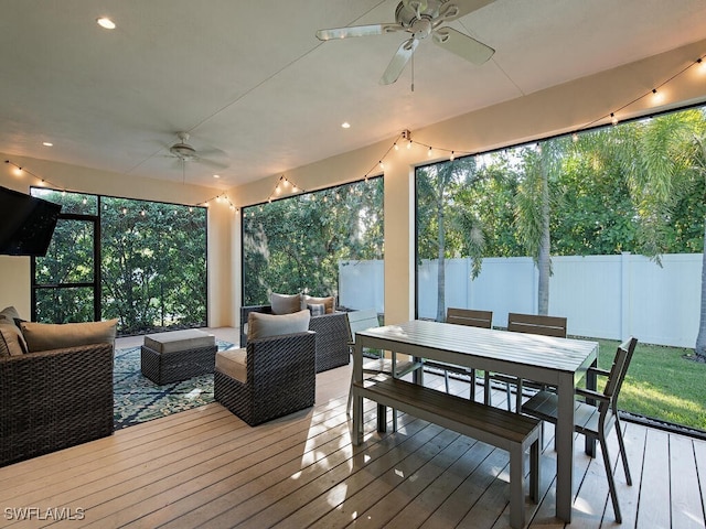 wooden terrace with ceiling fan and an outdoor hangout area