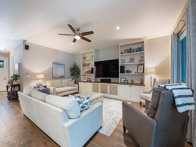 living room featuring ceiling fan and hardwood / wood-style floors