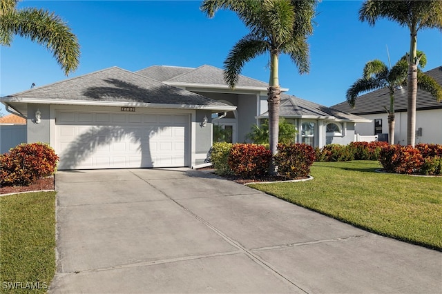 ranch-style house featuring a garage and a front lawn