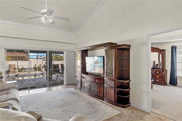 tiled living room with ceiling fan, ornamental molding, and high vaulted ceiling