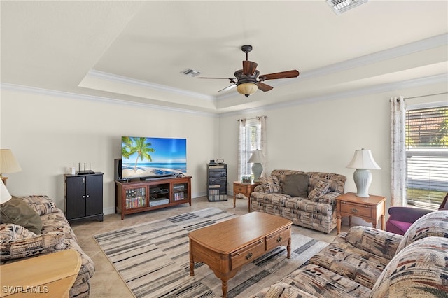 living room featuring light tile patterned floors, a raised ceiling, ceiling fan, and crown molding