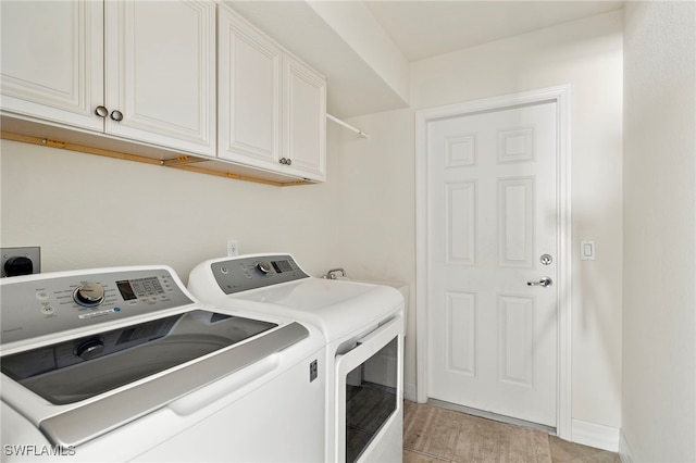 washroom with light hardwood / wood-style flooring, cabinets, and independent washer and dryer