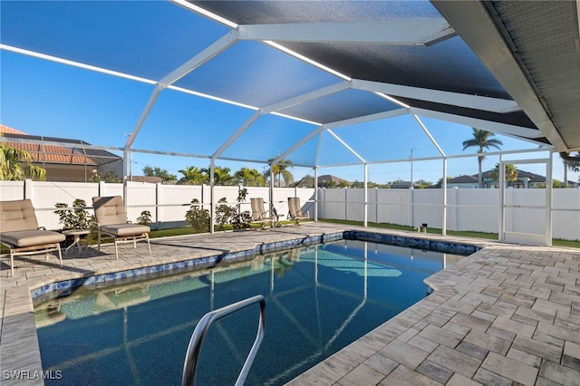 view of pool with a lanai and a patio