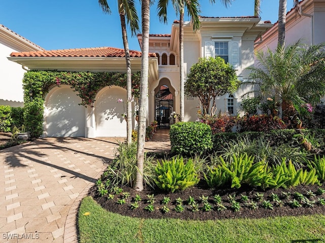 mediterranean / spanish-style house with a garage